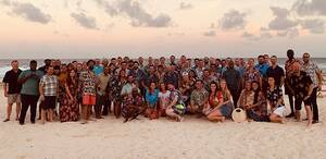 large group photo of people at the beach